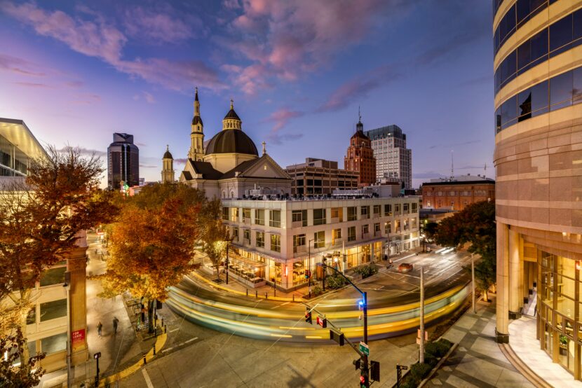 Best Argentina Travel Packing List A historic building with ornate architecture is illuminated at night, with city buildings in the background and a starry sky overhead. Cars and streetlights line the street below.