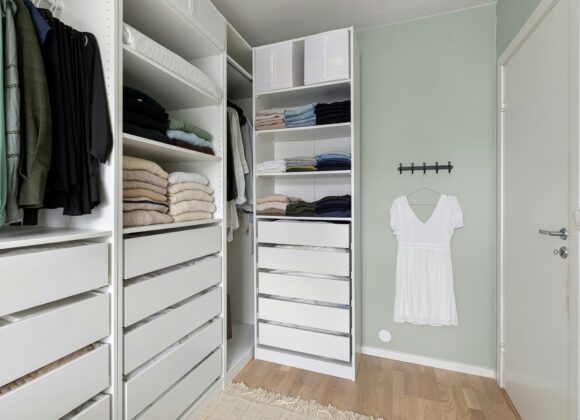An Honest Guide to Fit, Comfort, Durability & Style Spacious closet with shelves of neatly folded clothes, a hanging white dress, and soft lighting. The tone is organized, clean, and minimalist.