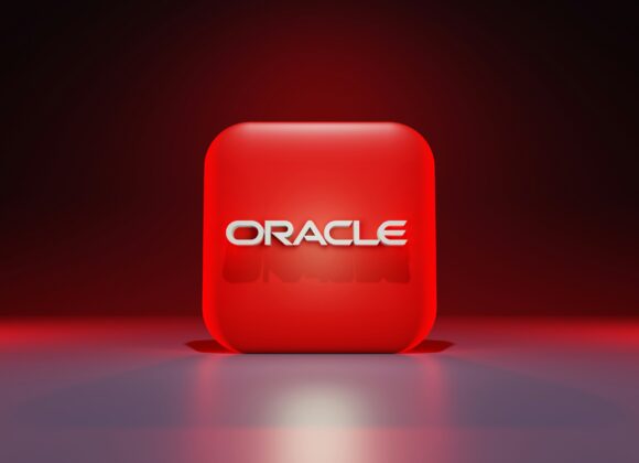 Oracle (ORCL) Stock Soars on AI-Fueled Growth Red cube with "ORACLE" in bold white font, set against a dark gradient background. The glowing effect creates a modern, tech-inspired feel.