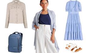 TFG-Travel Outfit Planner: Your Ultimate Travel Style Companion Alt text: Woman dressed in a blue shirt, light blue jacket, and white pants. Surrounding items include a beige jacket, blue dress, blue backpack, and white sandals.