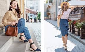 The Most Comfortable Wedges for Travel:the Heels at Home Two women in stylish outfits, one in jeans and a blouse sitting with a brown bag, the other in a ruffled skirt and hat standing on a sunny street. Casual elegance.