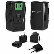 Voltage Converter vs Travel Adapter: How Do They Work Black universal travel adapter with multiple plug types shown. Front view includes green socket, various detachable plug components displayed below.