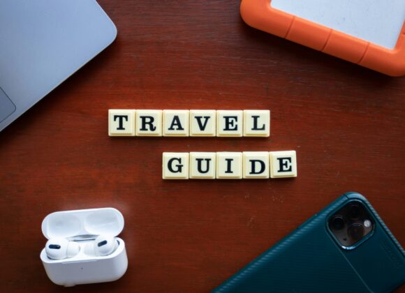 A Complete Fashion Guide for Travelers 1. Black and white photo of a city monument surrounded by urban buildings and streets. 2. A black and white image depicting a monument centrally located in a bustling cityscape. 3. Black and white photograph showing a monument in the heart of a city, framed by surrounding architecture.